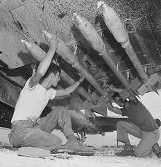 5-inch rockets being loaded onto a Marine Corsair