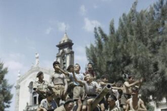 local_children_crowd_aboard_a_sherman_mk_iii_tank_of_the_county_of_london_yeomanry_in_the_village_of_milo_near_catania_in_sicily_august_1943-_tr1244