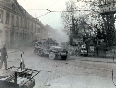 Halftracks_of_9th_Armored_Division,_1st_U.S._Army,_move_through_Engers,_Germany.__Town_was_heavily_mined_and_caution_in_approach_with_Armor_was_necessary._3-27-45